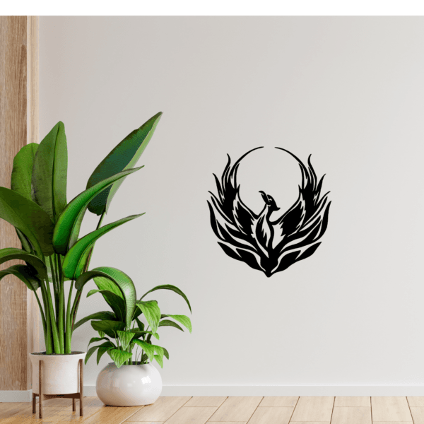 Modern tribal phoenix silhouette wall decor displayed on a neutral wall with green indoor plants in a minimalist interior setting
